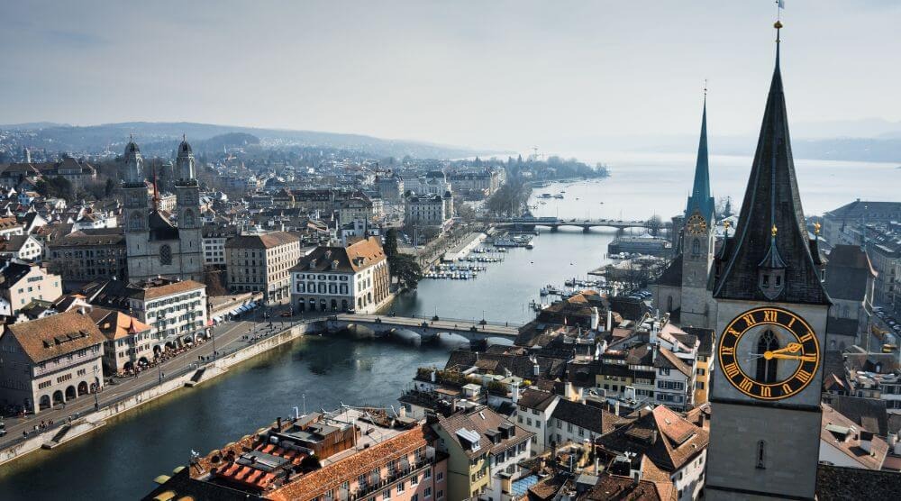 Zürich's old town along the Limmat — Grossmünster on the left, St. Peter's clock tower on the right.